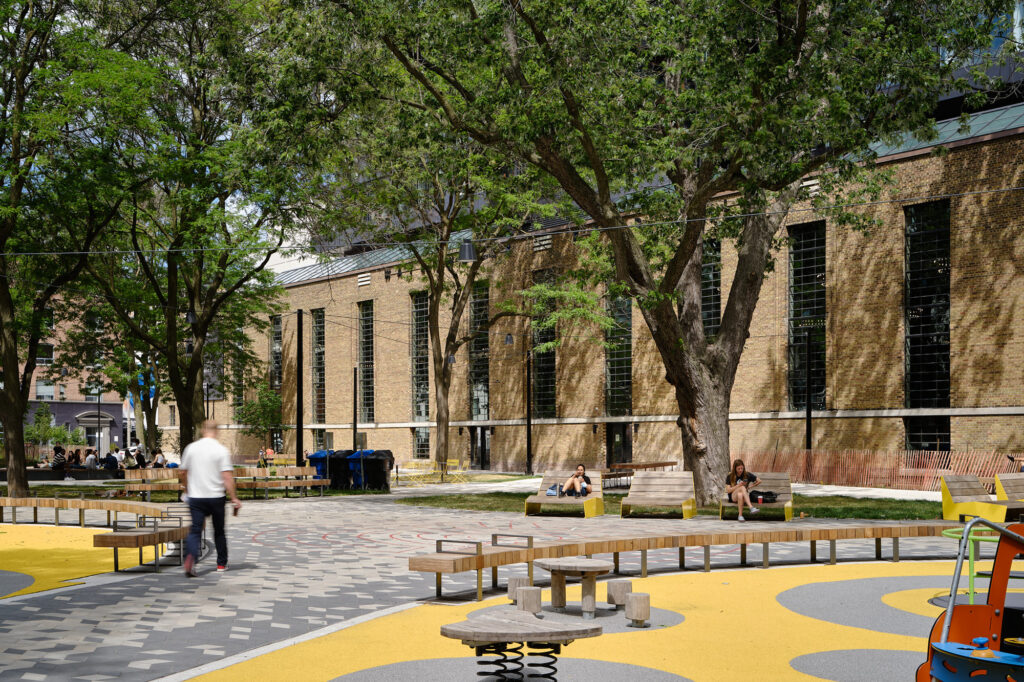 People sitting on benches in the Waterworks Food Hall courtyard